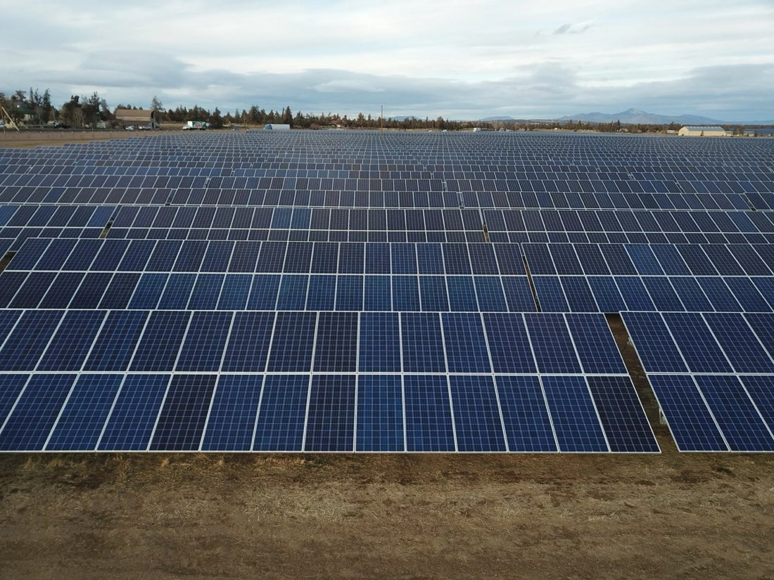 A completed utility-scale solar array extending to the horizon
